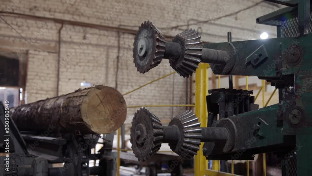 Processing of round timber logs for building wooden house. Removing bark from logs using a machine. Pattern of logs. Woodworking factory. Processing of round timber logs for building wooden house. Removing bark from logs using a machine. Pattern of logs. Woodworking factory.