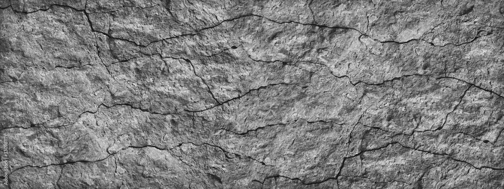 Cracked stone surface. Close-up. Gray abstract grunge background. Banner with gray rock texture. Copy space. Cracked stone surface. Close-up. Gray abstract grunge background. Banner with gray rock texture. Copy space.