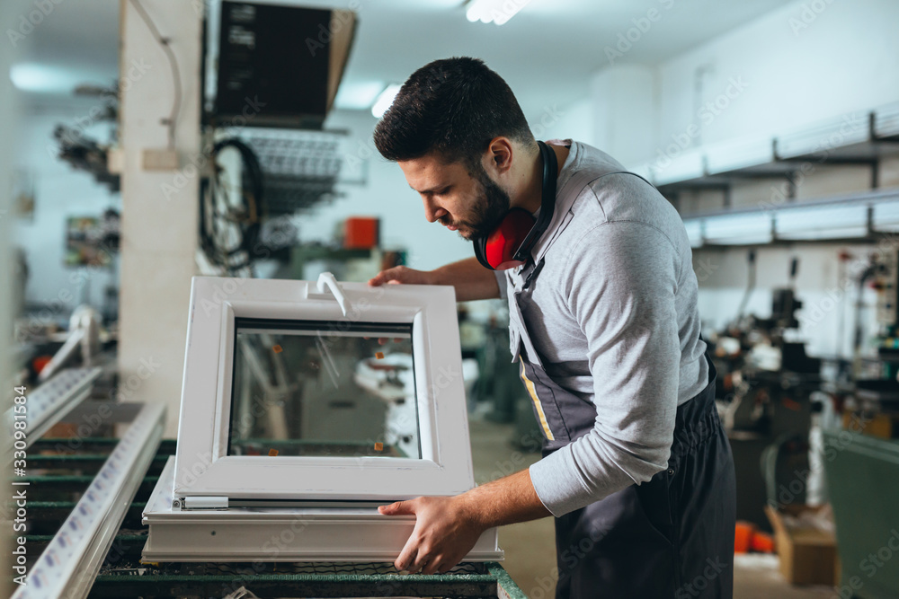 Aluminium and PVC industry worker making PVC or aluminium frames for windows and doors Aluminium and PVC industry worker making PVC or aluminium frames for windows and doors