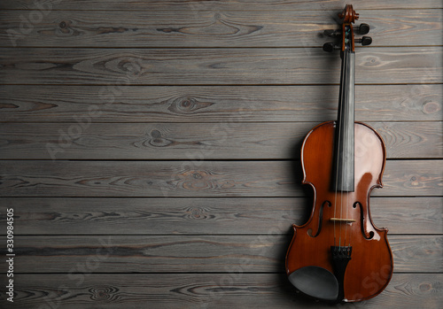 Classic violin on wooden background, top view. Space for text © New Africa