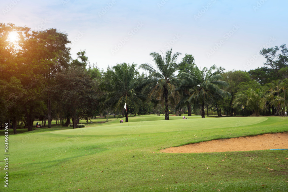 The evening golf course has sunlight shining down at golf course in Thailand The evening golf course has sunlight shining down at golf course in Thailand