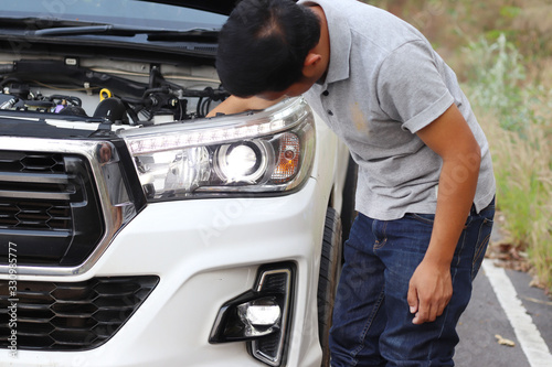 Image of a mechanic checking and fixing the engine © Konkhay