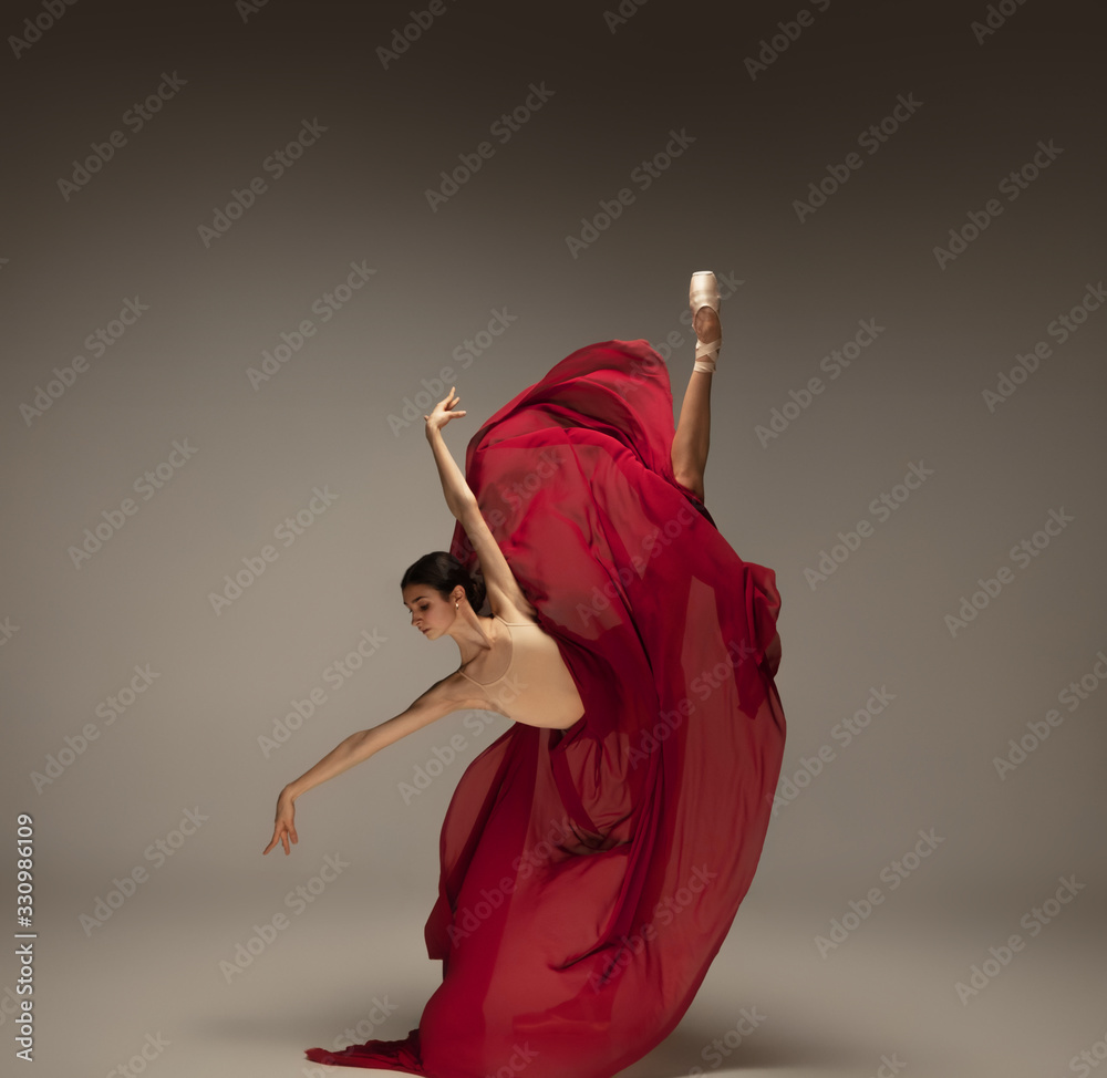 Passioned in motion. Graceful classic ballerina dancing on grey studio background. Deep red cloth. The grace, artist, movement, action and motion concept. Looks weightless, flexible. Fashion, style. - obrazy, fototapety, plakaty 