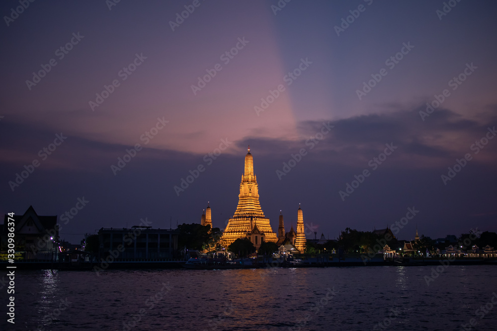 The royal temple which called Wat Arun nex to the grand river Chao Phraya river in the night time.