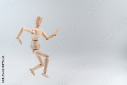 Wooden dummy proudly presents some invisible thing, isolated on white background, copy space for your object or text