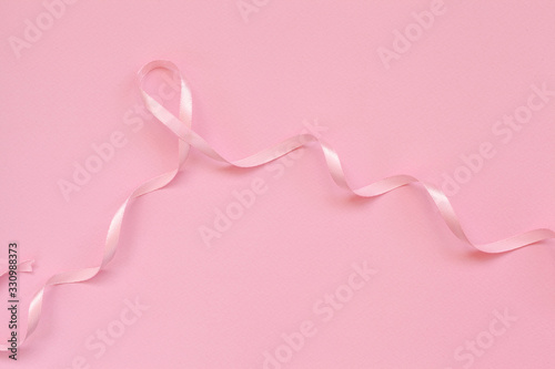 Pink ribbon breast cancer on pink background.