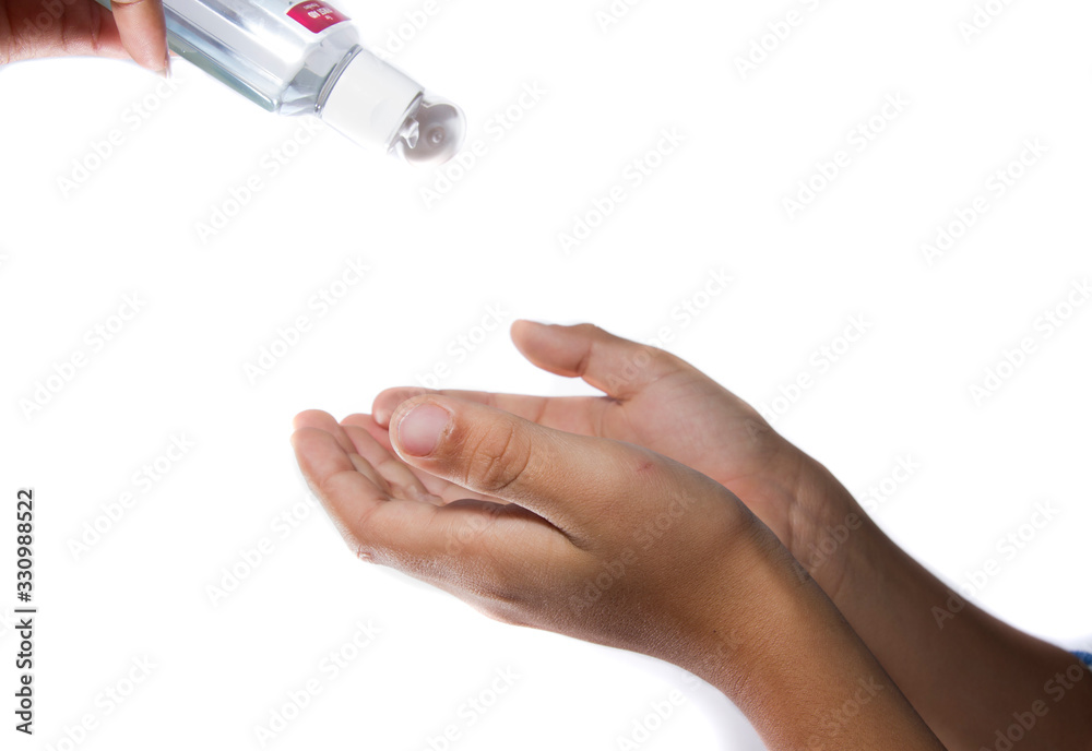 isolated hands of boy pouring disinfectant to prevent bacteria in white background