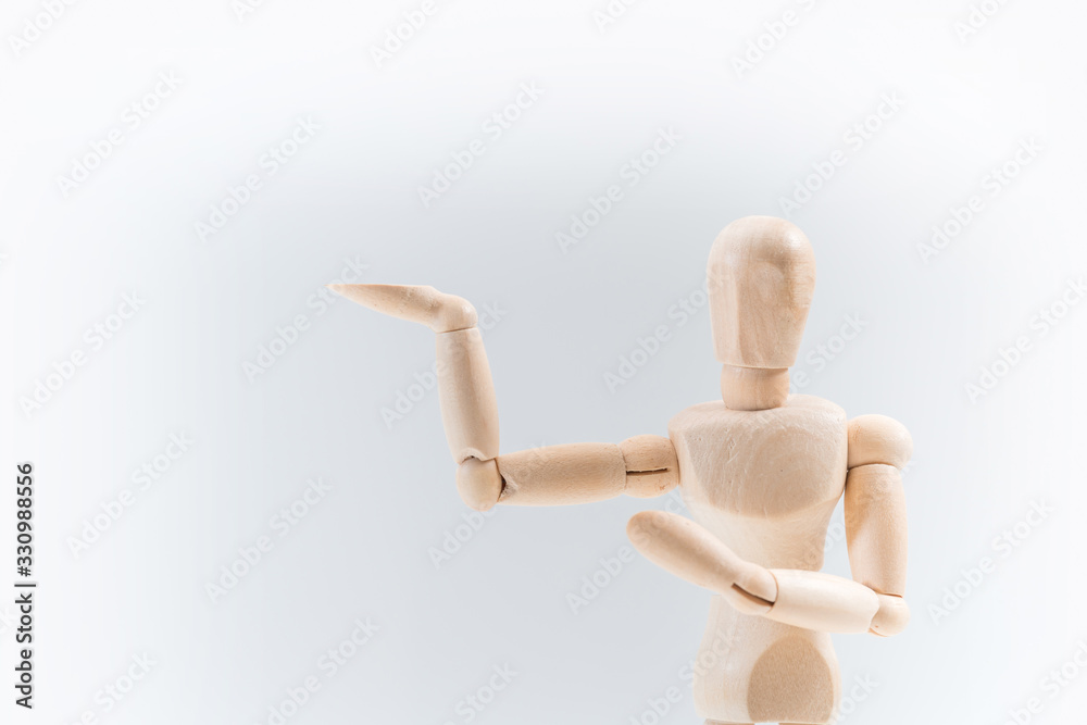 Wooden dummy proudly presents some invisible thing, isolated on white background, copy space for your object or text Wooden dummy proudly presents some invisible thing, isolated on white background, copy space for your object or text