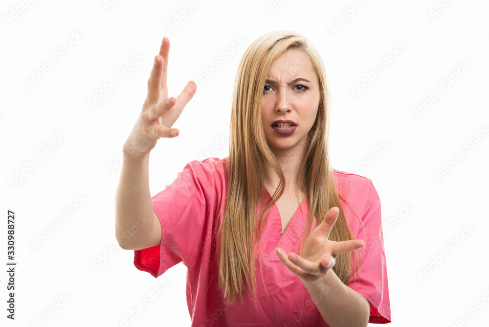 Portrait of female nurse wearing scrubs explaining and gesturing Portrait of female nurse wearing scrubs explaining and gesturing