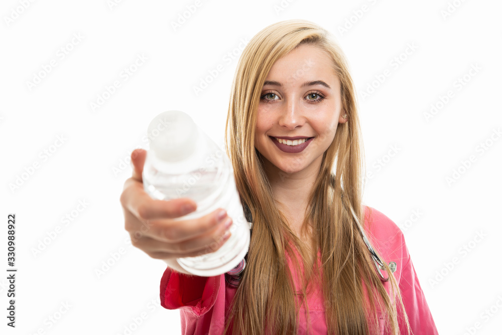 Portrait of female doctor wearing scrubs handing bottle of water Portrait of female doctor wearing scrubs handing bottle of water