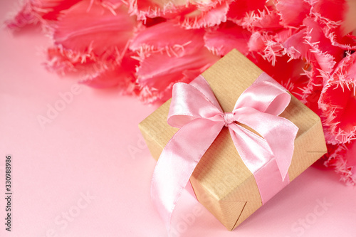 Present or gift box with Beautiful bouquet of pink tulips flowers on pink background. Card Concept for holidays © Volha Zaitsava