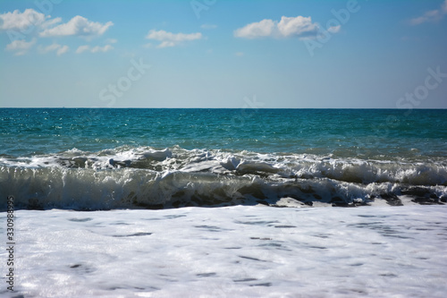 Fototapeta Naklejka Na Ścianę i Meble -  sea wave with foam and blue sky