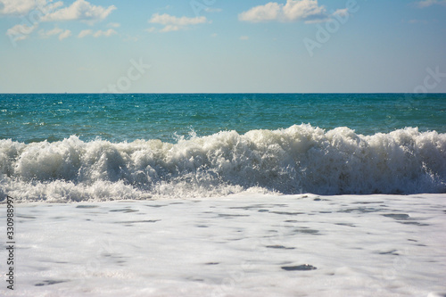 Fototapeta Naklejka Na Ścianę i Meble -  sea wave with foam and blue sky