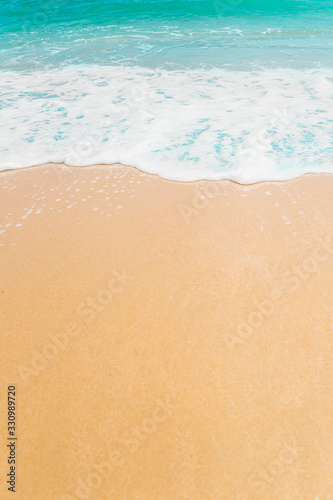 Wave and sand beach background with copy space.