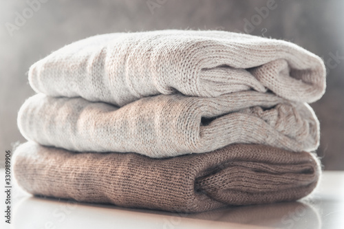 A stack of knitted sweaters ,the concept of warmth and comfort, hobby , background,closeup