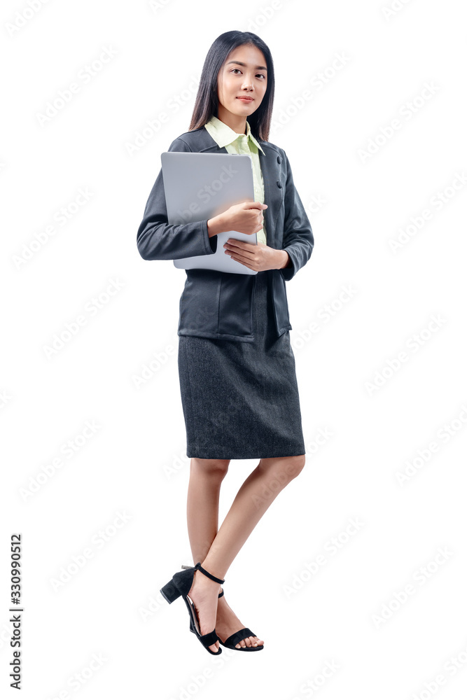 Asian businesswoman standing while carrying laptop Asian businesswoman standing while carrying laptop