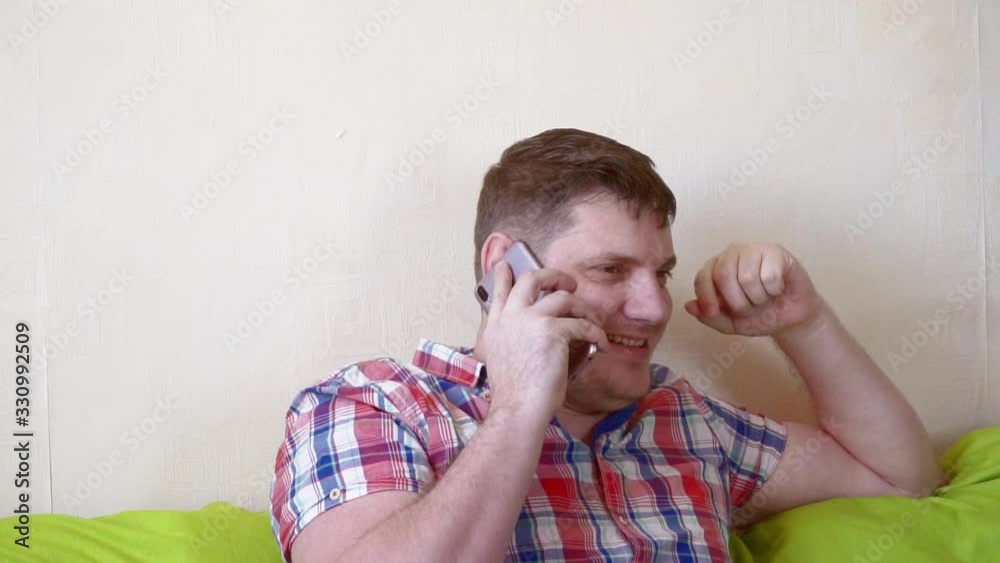 modern cheerful middle-aged man who uses a smartphone modern cheerful middle-aged man who uses a smartphone