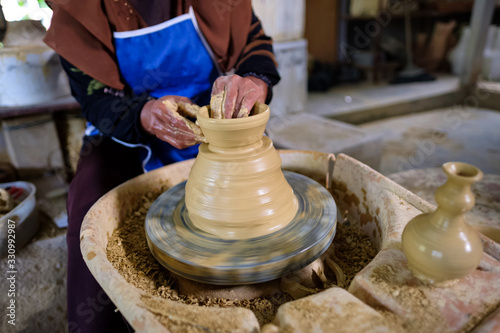 Closeup of Local woman demonstrates on making traditional clay jar called 