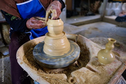 Closeup of Local woman demonstrates on making traditional clay jar called 