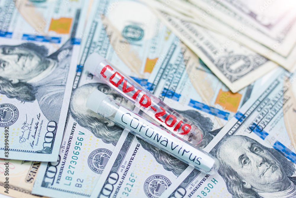 COVID 2019 coronavirus medical tube and dollars money. Concept of economic disaster from a pandemic. COVID 2019 coronavirus medical tube and dollars money. Concept of economic disaster from a pandemic.