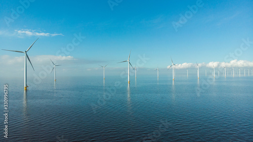 Windmill row of windmills in the ocean by the lake Ijsselmeer Netherlands, renewable energy windmill farm Flevoland