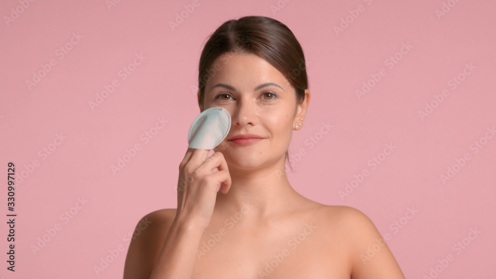 Brunette woman closeup portrait peel her face with a acid peeling pads. Black head nose pore peeling Brunette woman closeup portrait peel her face with a acid peeling pads. Black head nose pore peeling
