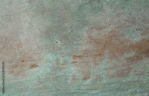 Background of green oxidized bronze with potholes and interspersed .. Texture of oxides on brass