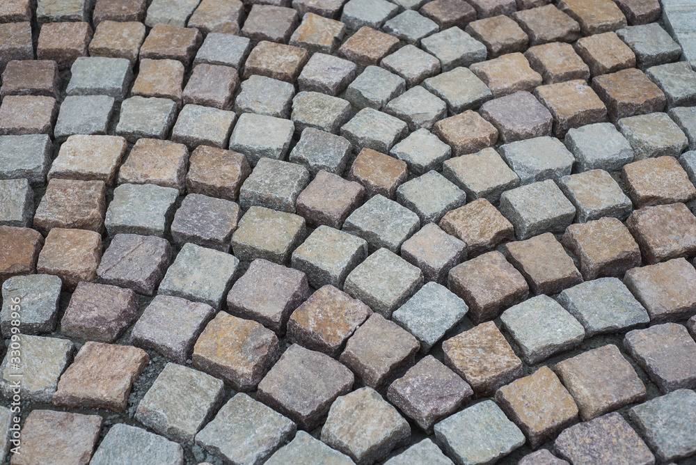 Closeup of geometric cobblestone construction site in the street Closeup of geometric cobblestone construction site in the street