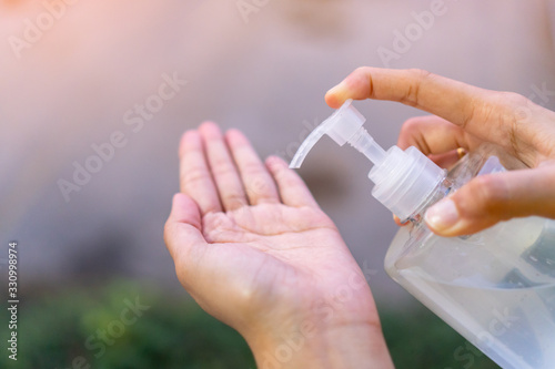  Washing your hand by alcohol sanitizer gel pump dispenser for protecting infection from a Covid-19 virus or Coronavirus infection and killing germs other viruses.Hygiene and Healthcare concept.