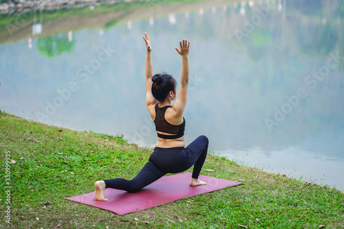 Woman do yoga relax at the outdoors nature background.