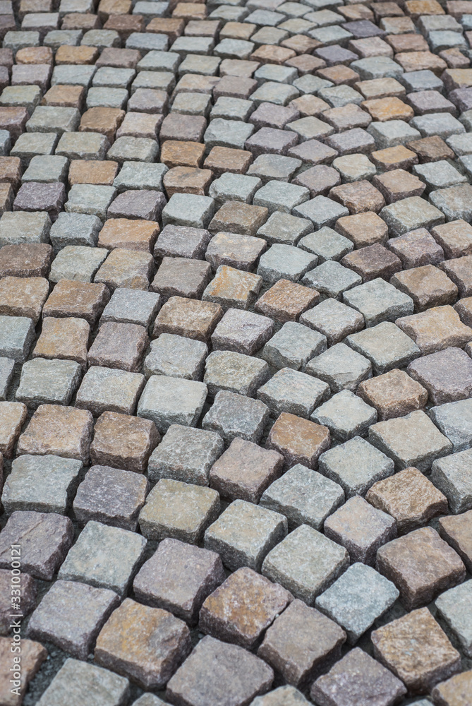 Closeup of geometric cobblestone construction site in the street Closeup of geometric cobblestone construction site in the street