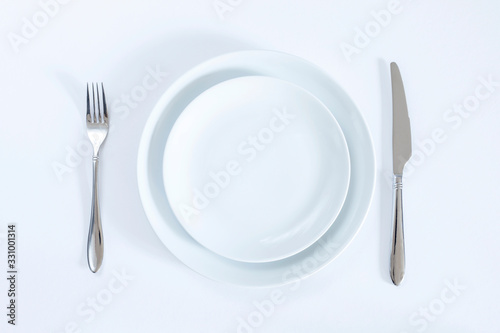 empty plate with fork and knife isolated on white