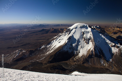 View of Pomerape volcano from the top of Parinacota volcano. photo