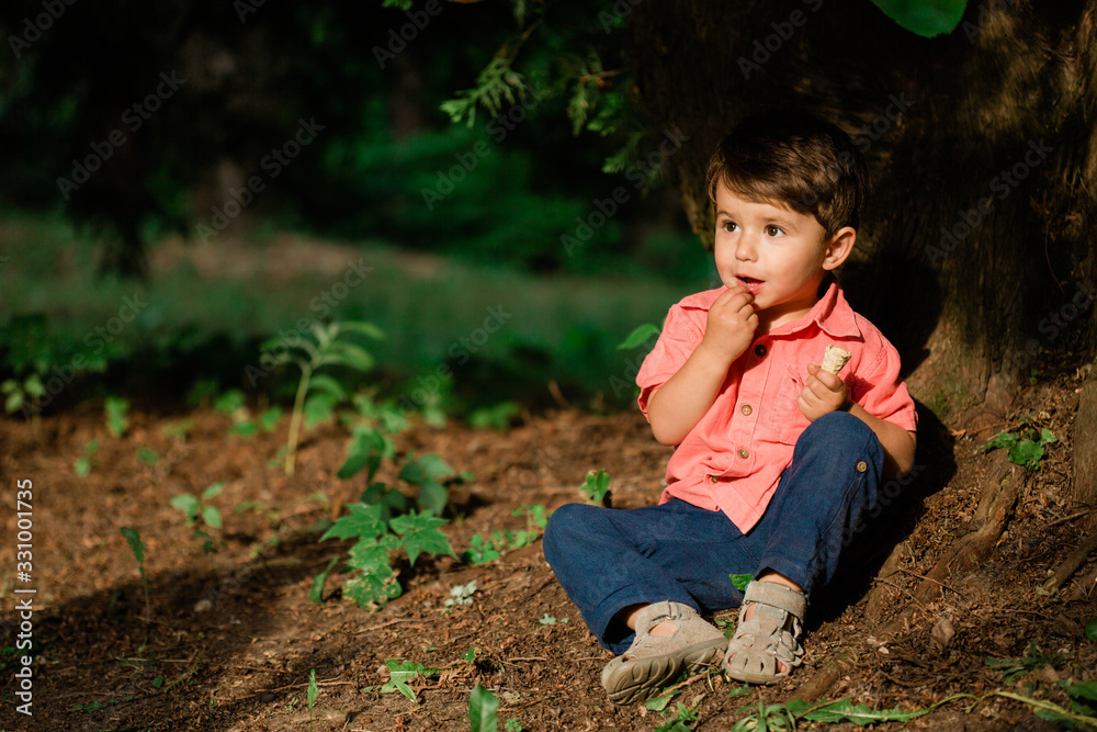 Cute little boy having fun in summer park. Happy child outdoors Cute little boy having fun in summer park. Happy child outdoors