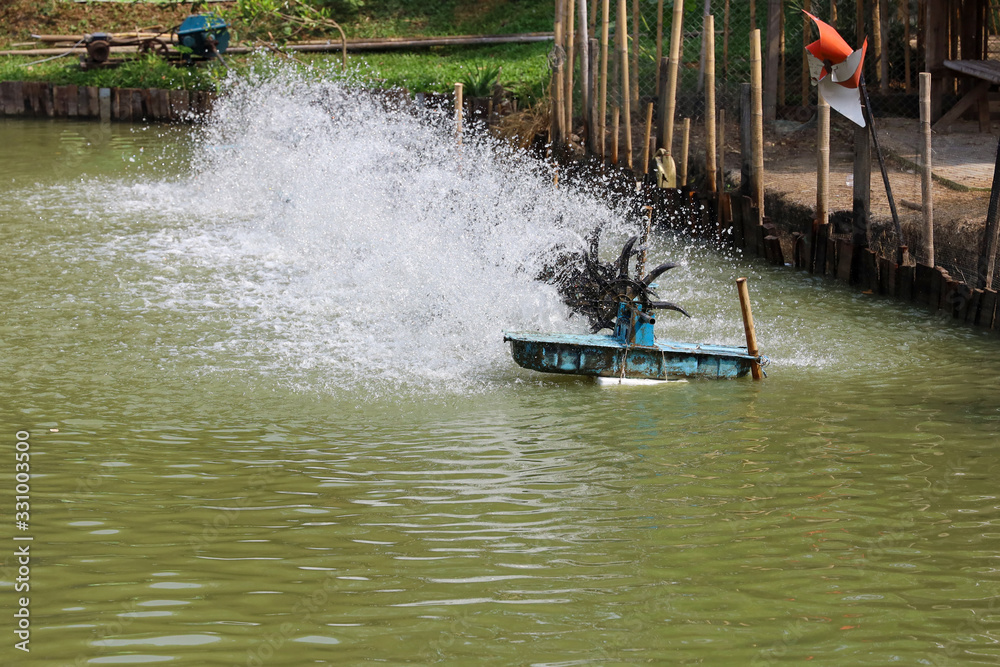 Water Hitting Machine The Water turbine pump machine hit water on pool farm at thailand Stock ...