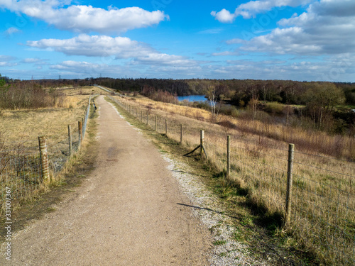 Path through Fairburn Ings Nature Reserve, West Yorkshire, England, with a view of the River Aire