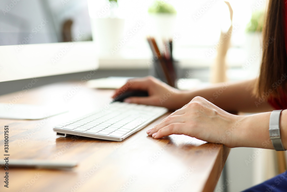 Hands of woman working on computer with mouse in office Hands of woman working on computer with mouse in office