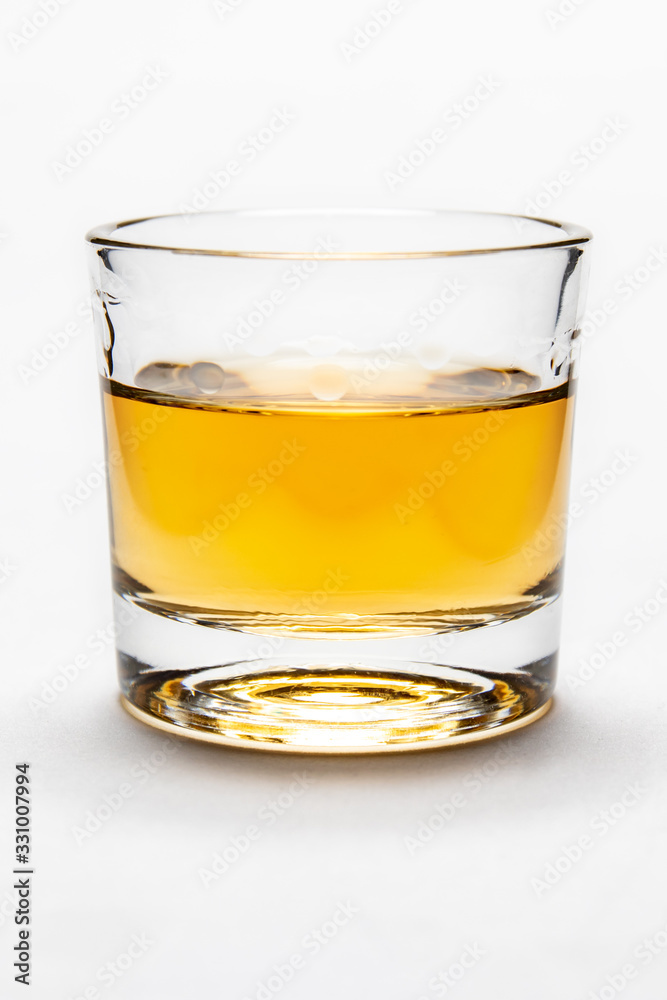 Studio shot of rum on white background in shot glass Studio shot of rum on white background in shot glass