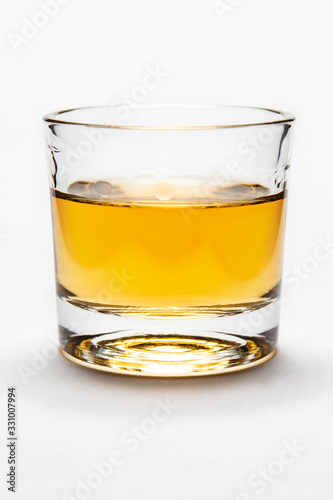Studio shot of rum on white background in shot glass