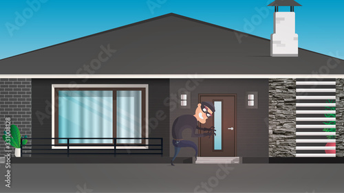 A thief sneaks into the house. The robber is trying to crack the door. Sign of a robbery. A surveillance camera recorded a thief. Security concept. 