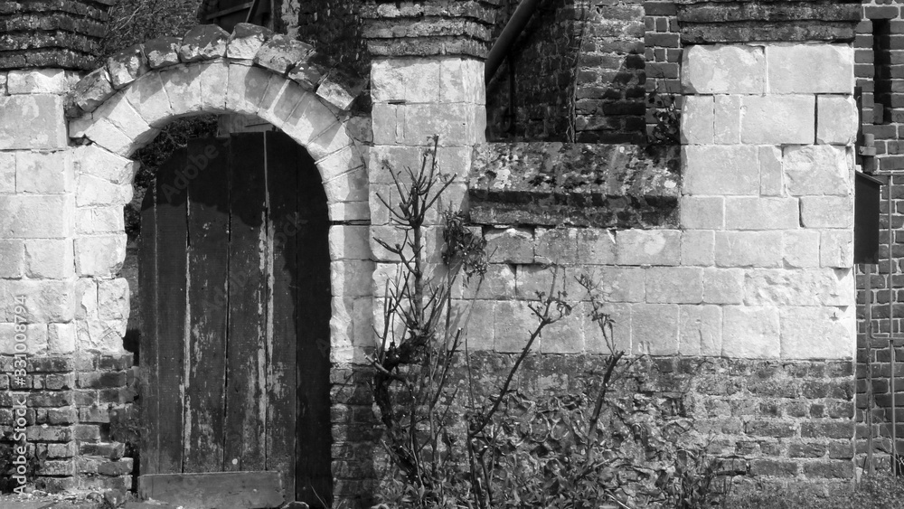 Old entrance gate to a courtyard in black and white Old entrance gate to a courtyard in black and white