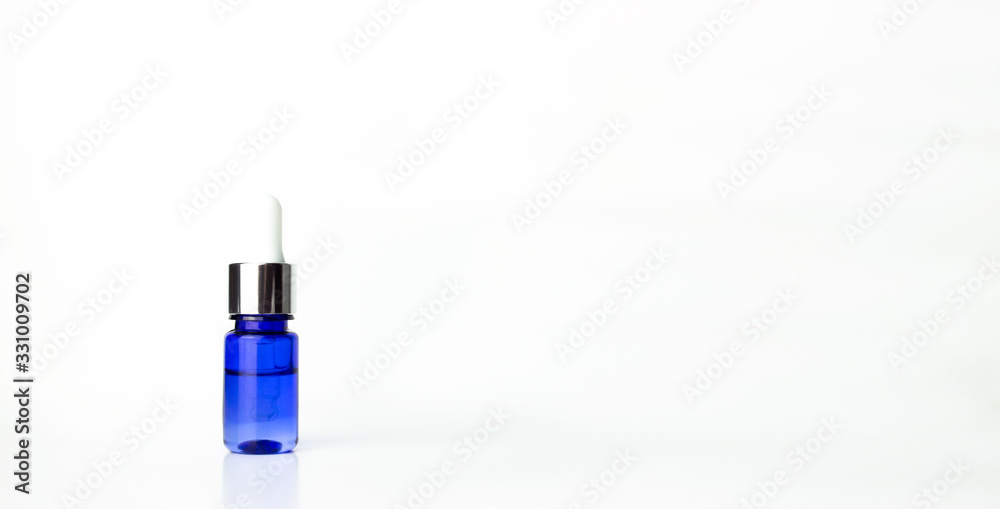 Blue dropper glass with moisturizing hyaluron serum isolated on white background with copy space. Organic cosmetic. Beauty skincare concept. Web banner template. Blue dropper glass with moisturizing hyaluron serum isolated on white background with copy space. Organic cosmetic. Beauty skincare concept. Web banner template.
