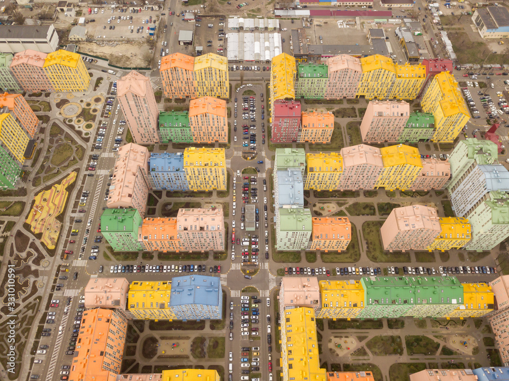 Fototapeta premium Colorful houses in Comfort Town district in Kyiv at cloudy weather, multi-floor apartment buildings complex. Aerial panoramic drone photo, 17 March 2020.