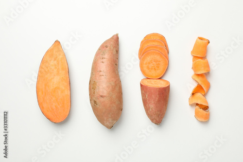 Flat lay with sweet potato on white background, top view