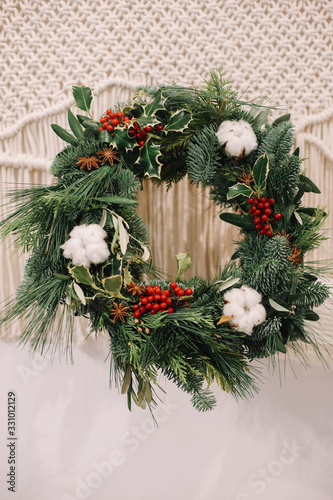 Base for Christmas wreath. Christmas decorations. Christmas wreath. Florist making Christmas wreath. View of female hands holding a wreath.