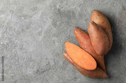 Sweet potato on grey background, top view. Vegetables