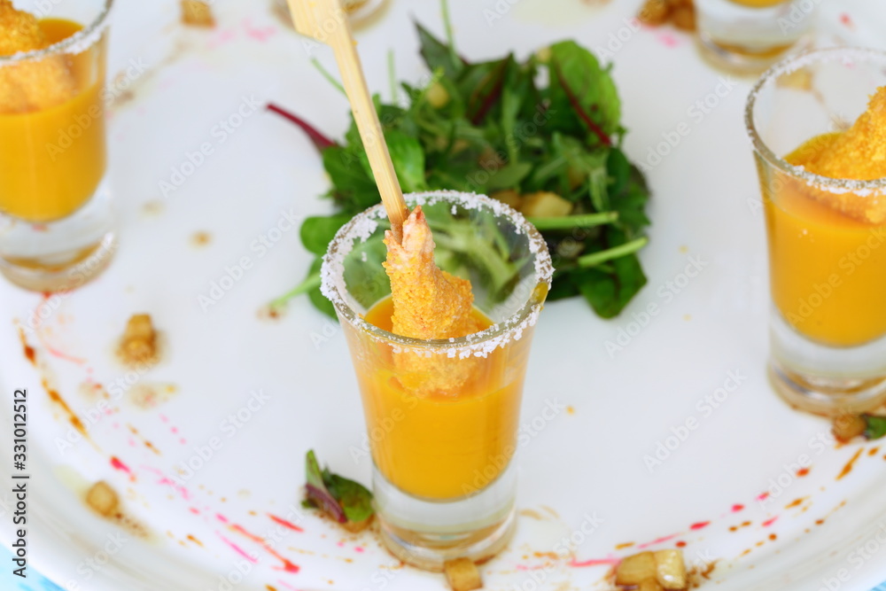 Shrimp in breadcrumbs with mango sauce on a white plate Shrimp in breadcrumbs with mango sauce on a white plate