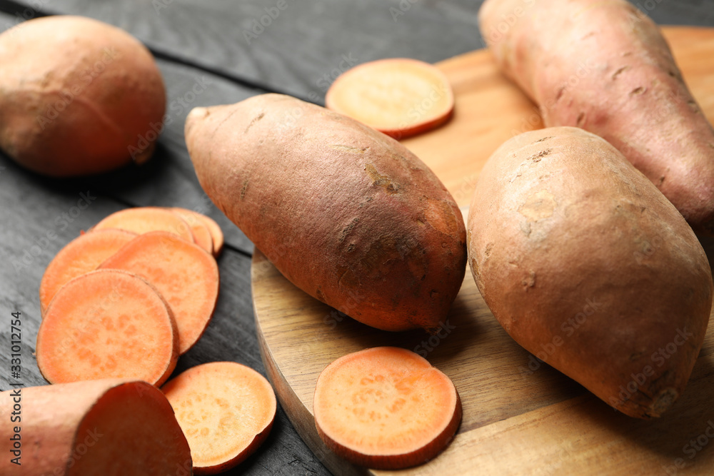 Sweet potato on wooden background, close up. Vegetables Sweet potato on wooden background, close up. Vegetables