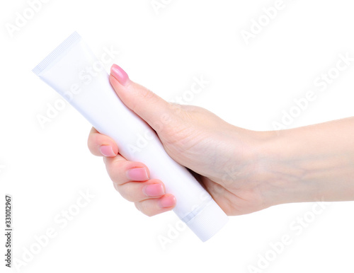 White tube toothpaste dental care in hand on white background isolation