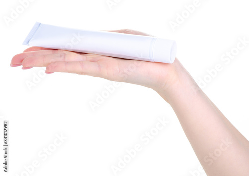 White tube toothpaste dental care in hand on white background isolation